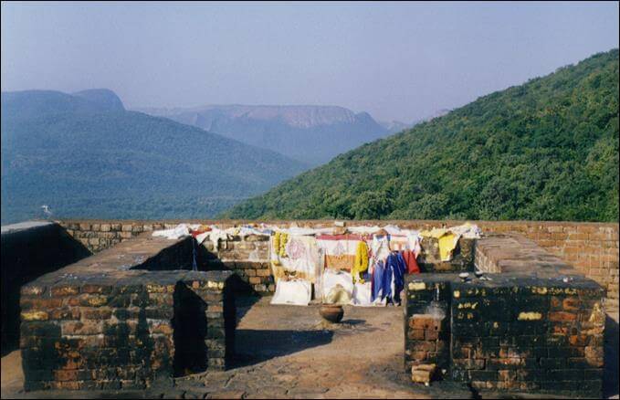 photo of The peak at Grdhrakuta located in Rajgir - decorated by religious banners left by pilgrims - site of many of Buddha's Dharma Teachings.